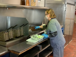 Minerva in the kitchen.Female standing in the kitchen, making healthy food